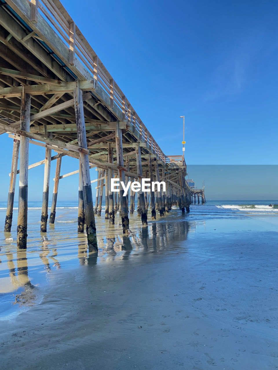 PIER ON SEA AGAINST BLUE SKY