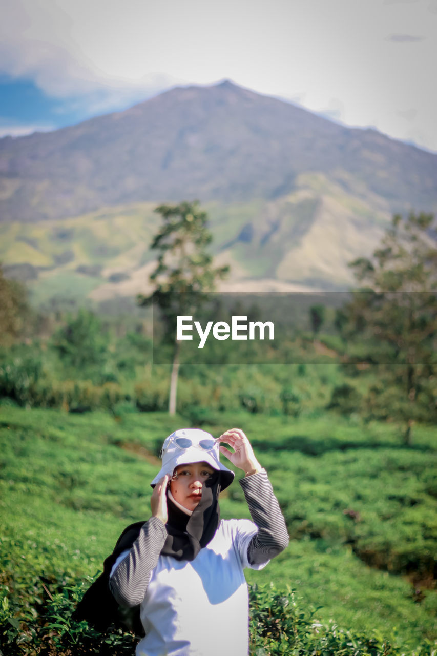 Portrait of woman against mountain range