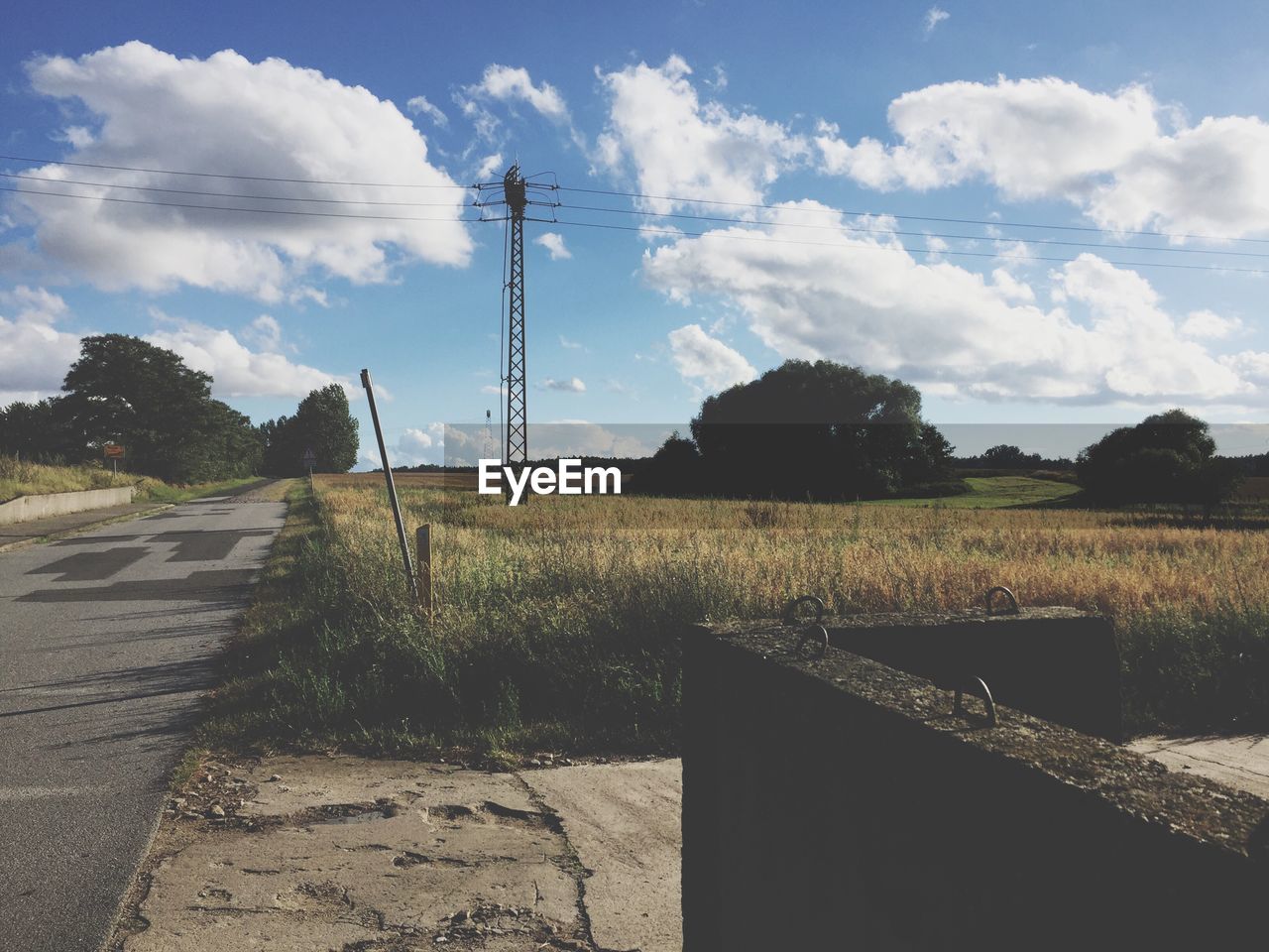 Road by landscape against sky