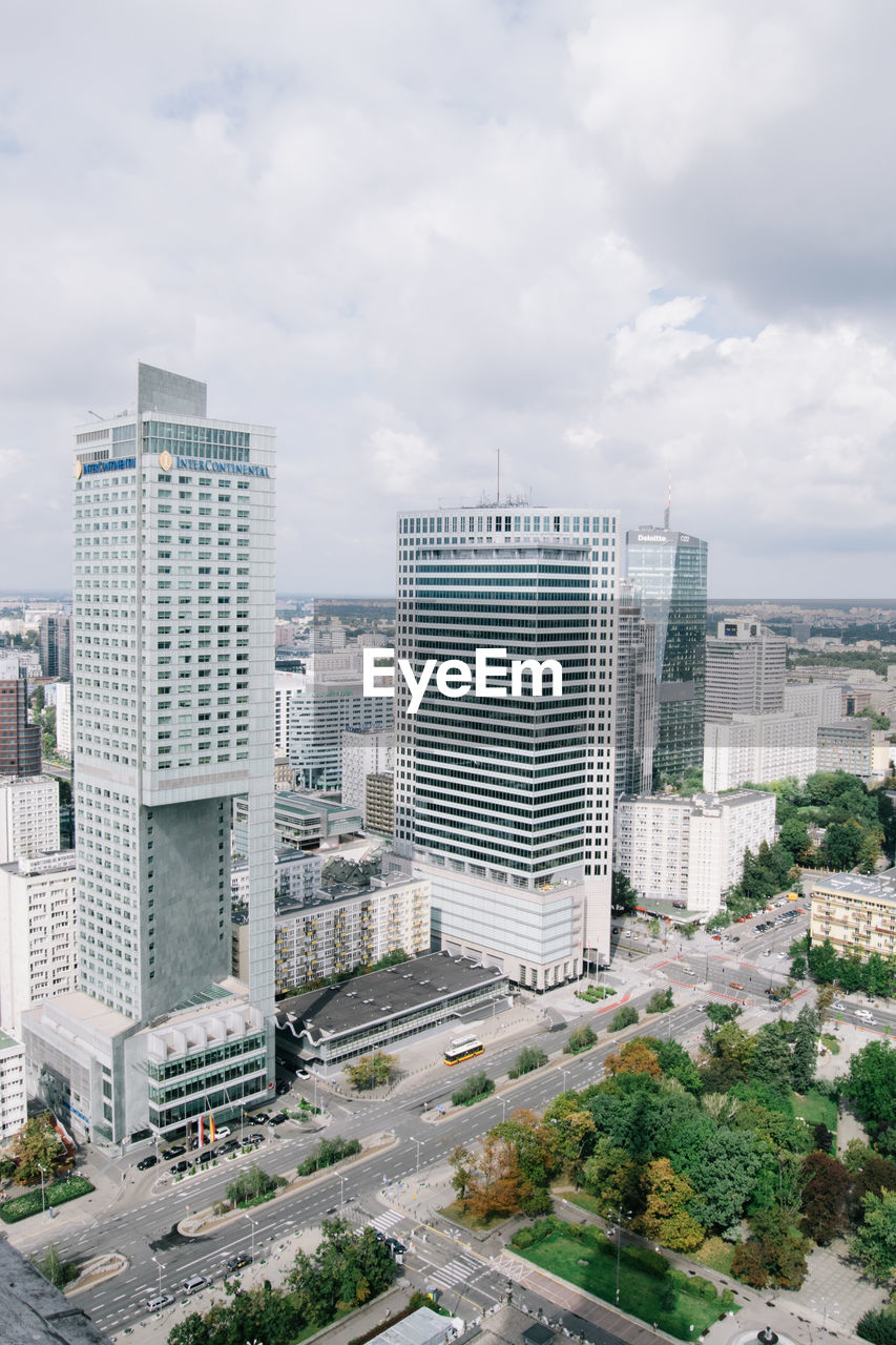 Buildings against cloudy sky