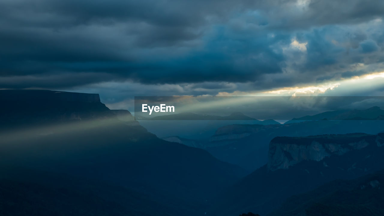 scenic view of mountains against sky during sunset