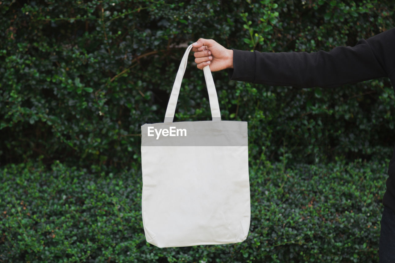 Man holding bag canvas fabric for mockup,ecology concept.