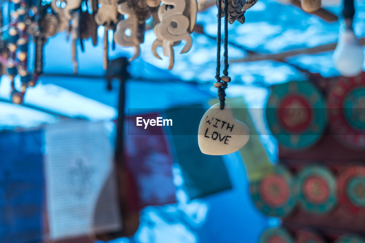 Close-up of text on bracelet hanging at store