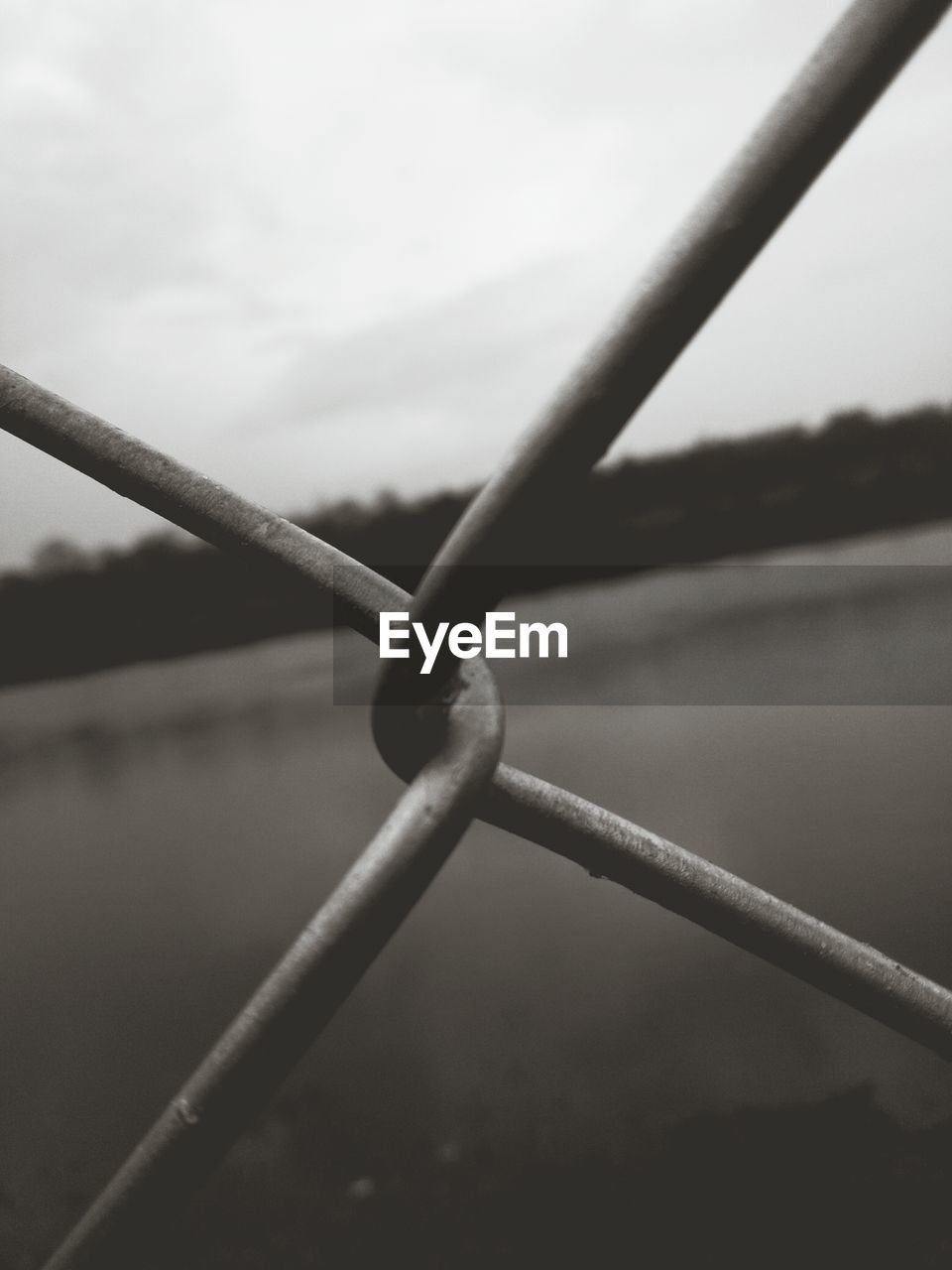 CLOSE-UP OF BARBED WIRE AGAINST SKY IN WATER