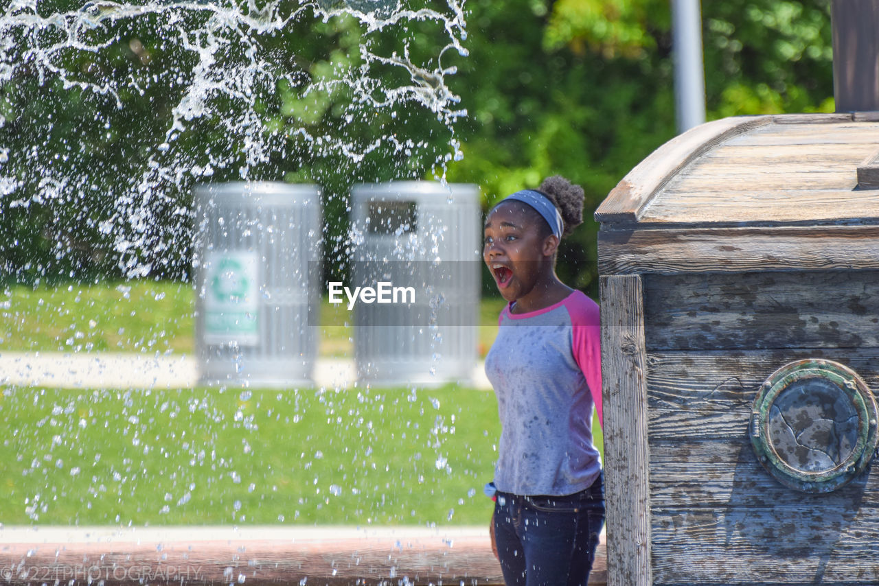 Girl being splashed with water