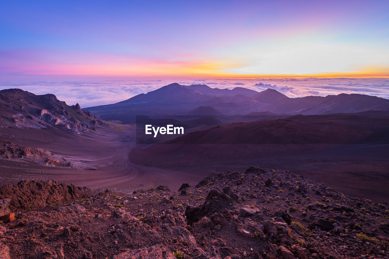 Scenic view of mountains against sky during sunrise