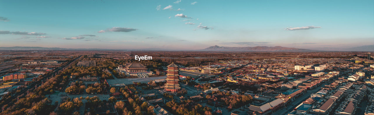 Aerial view of cityscape against sky during sunset