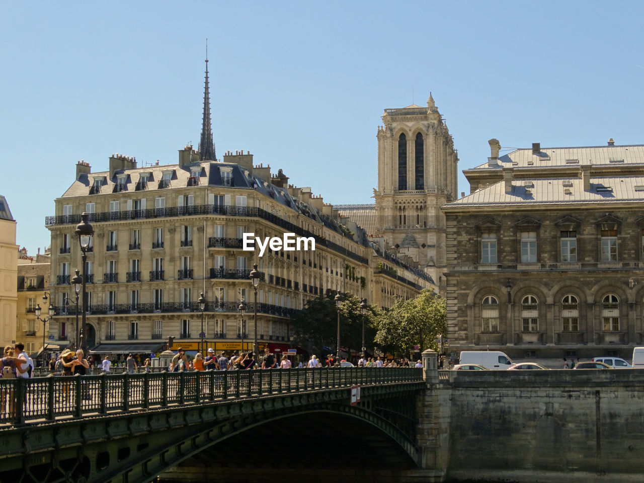 Bridge over river against buildings in city