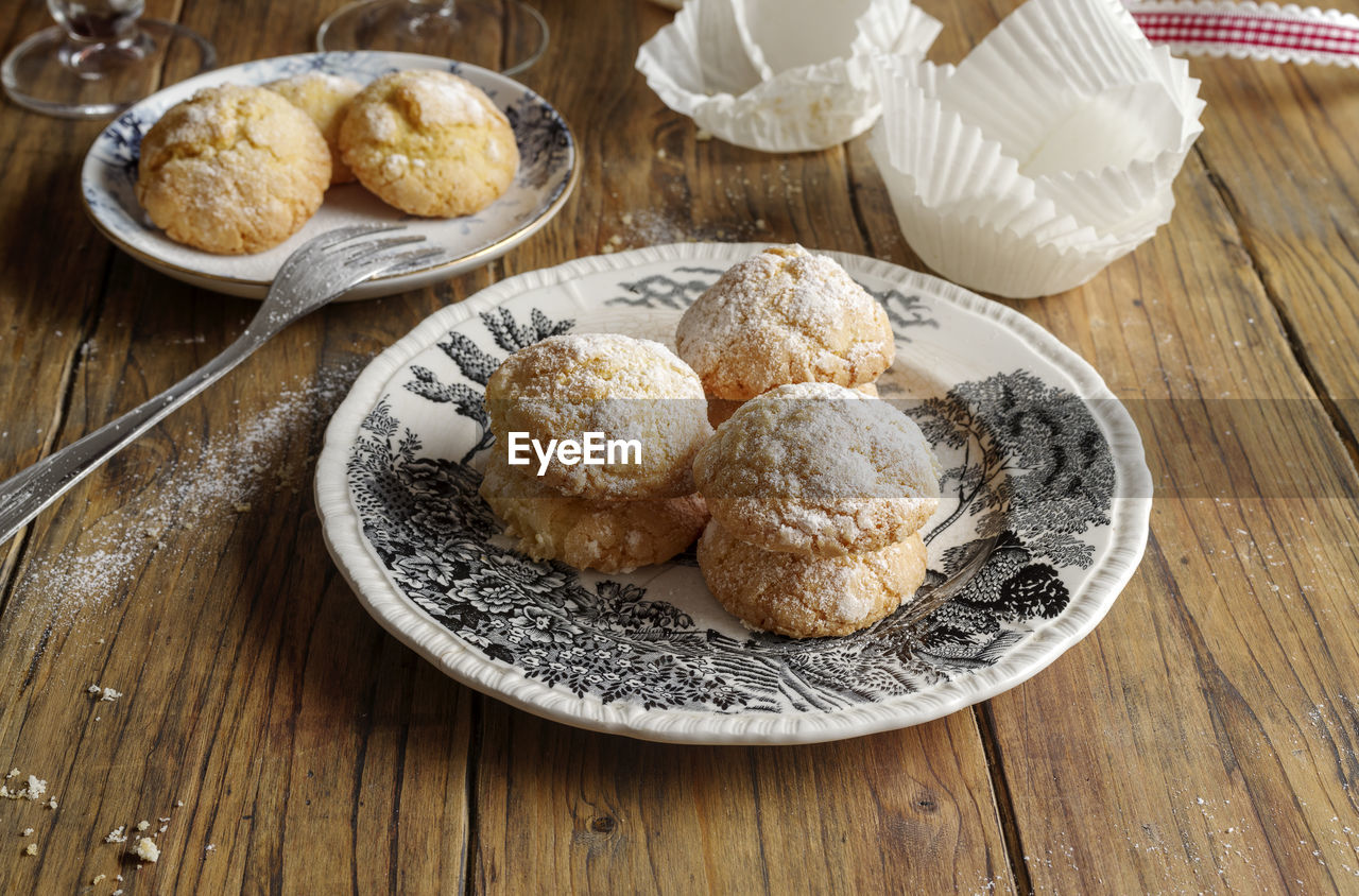 food and drink, food, freshness, table, baked, dessert, wood, plate, sweet food, breakfast, dish, no people, indoors, meal, high angle view, still life, produce, sweet, bread, healthy eating, powdered sugar