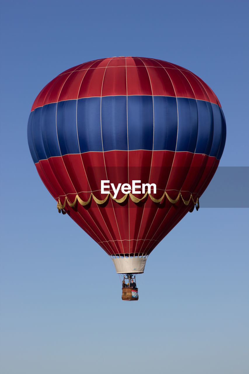 Low angle view of hot air balloon against clear blue sky