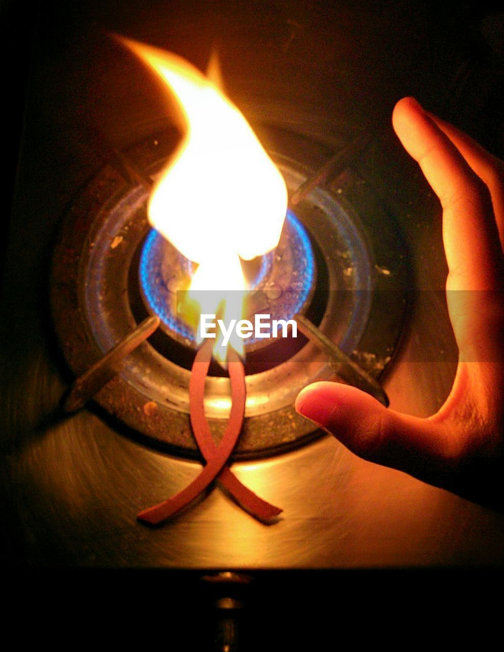 CLOSE-UP OF LIT CANDLES
