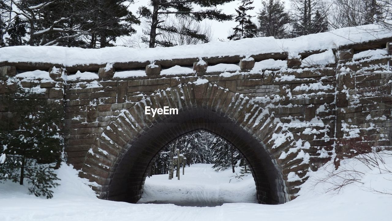 Snow covered stone bridge