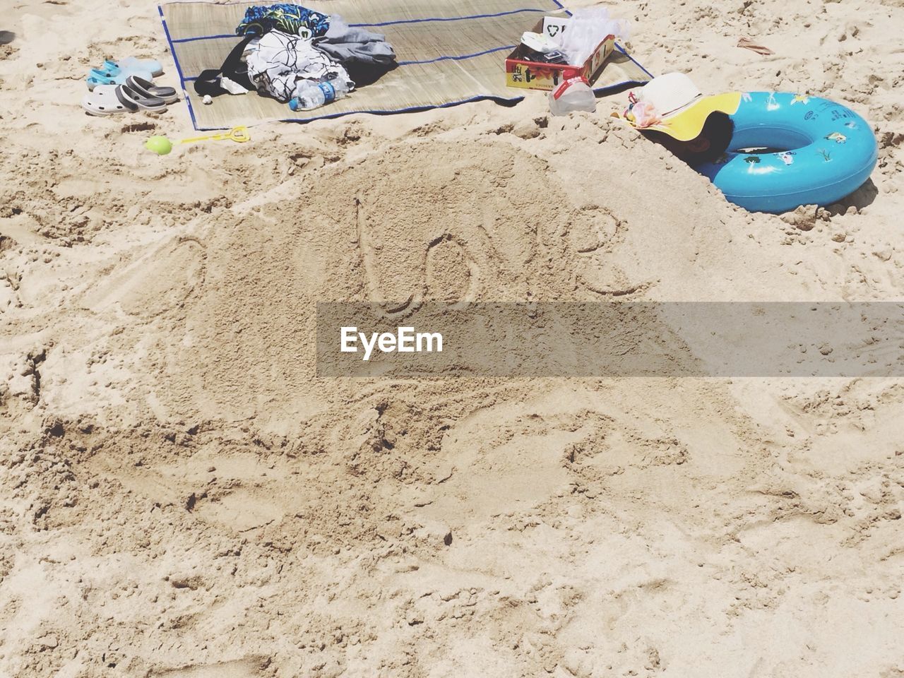 Love text written on sand at beach
