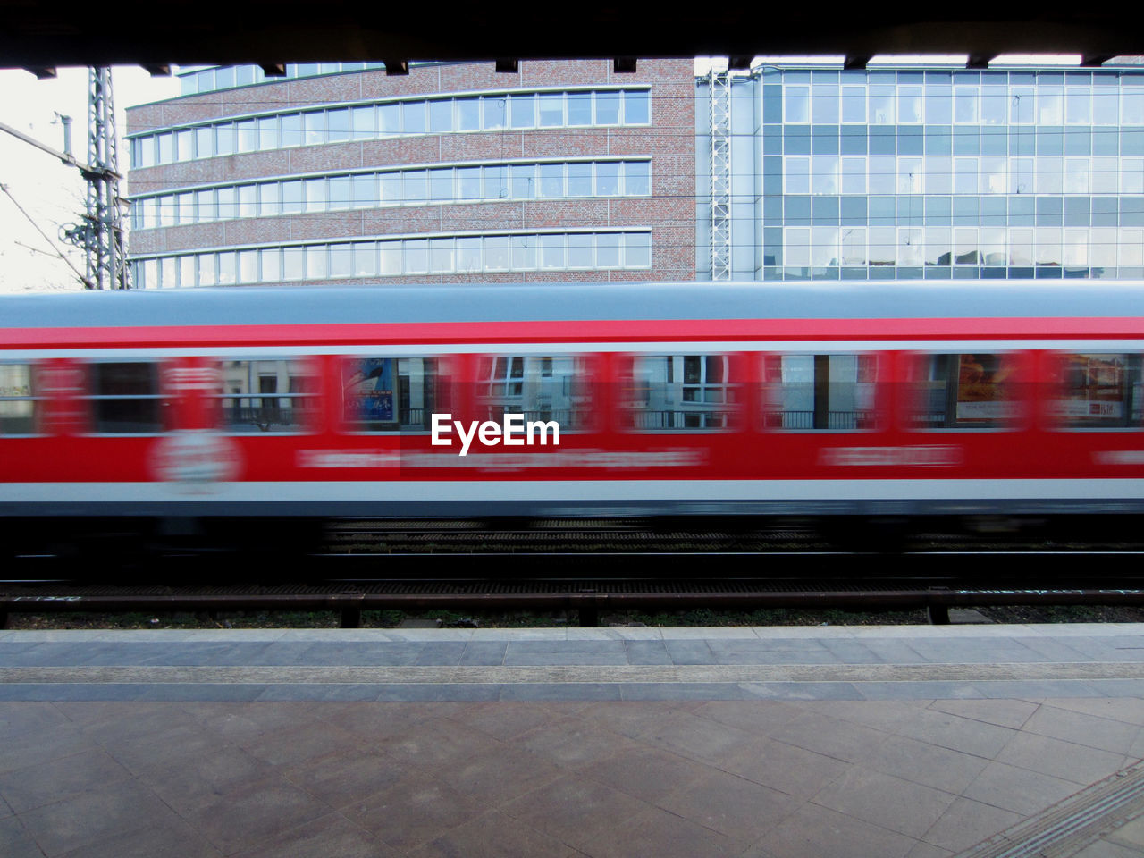 Blurred motion of train moving at station against building