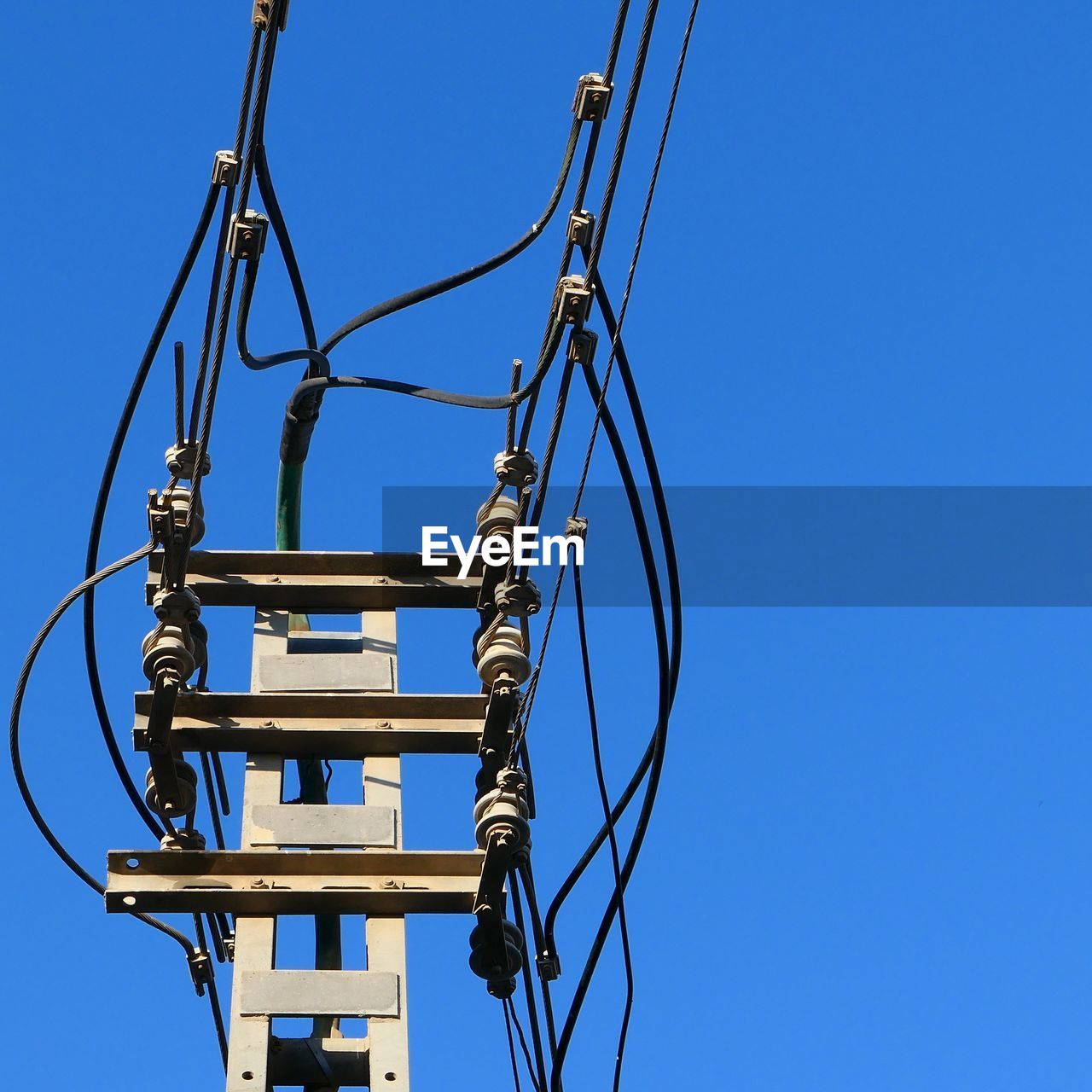 Power line against clear blue sky