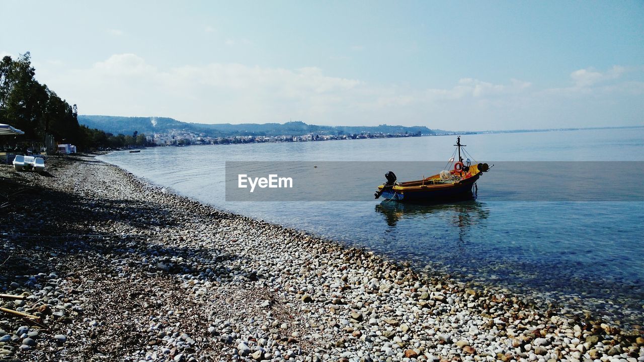 BOAT ON SEA AGAINST SKY