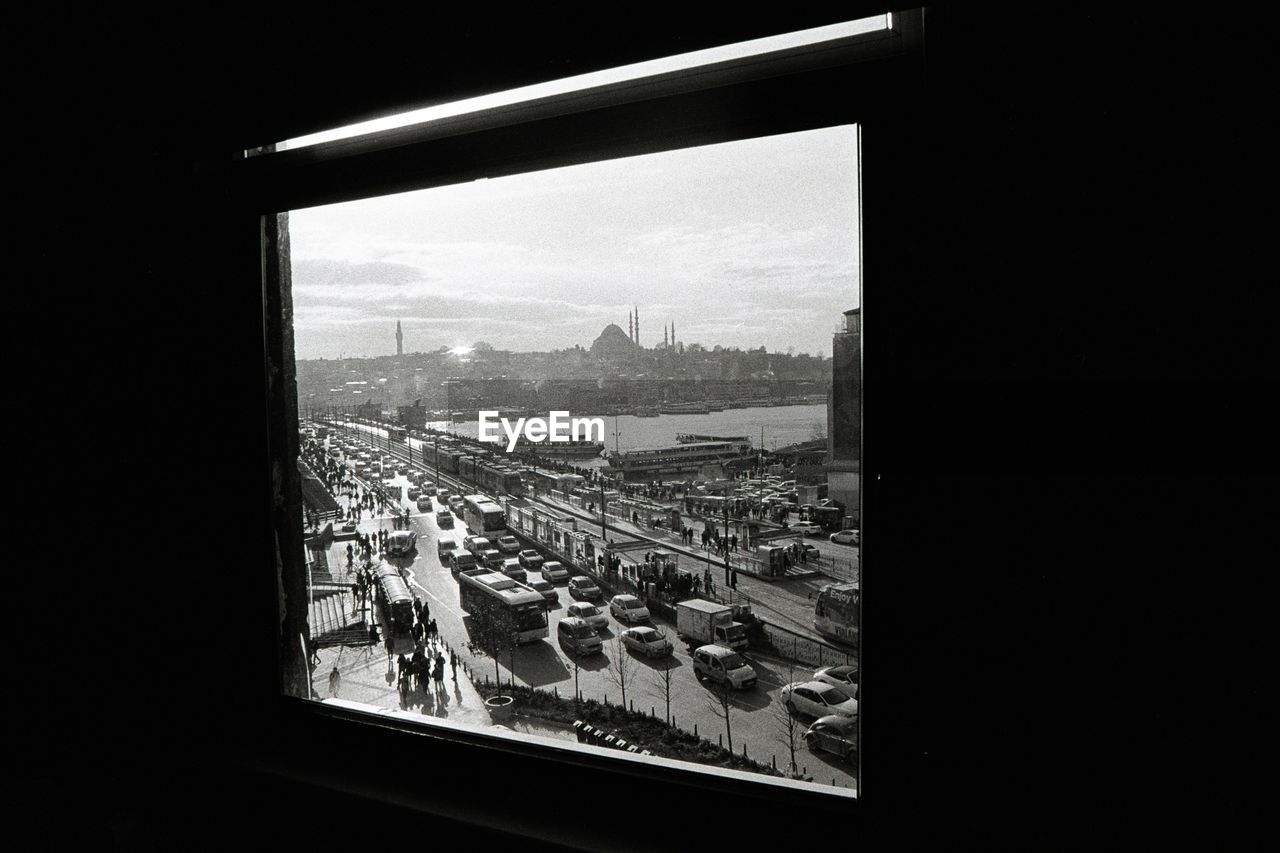 HIGH ANGLE VIEW OF CITY SEEN THROUGH WINDOW