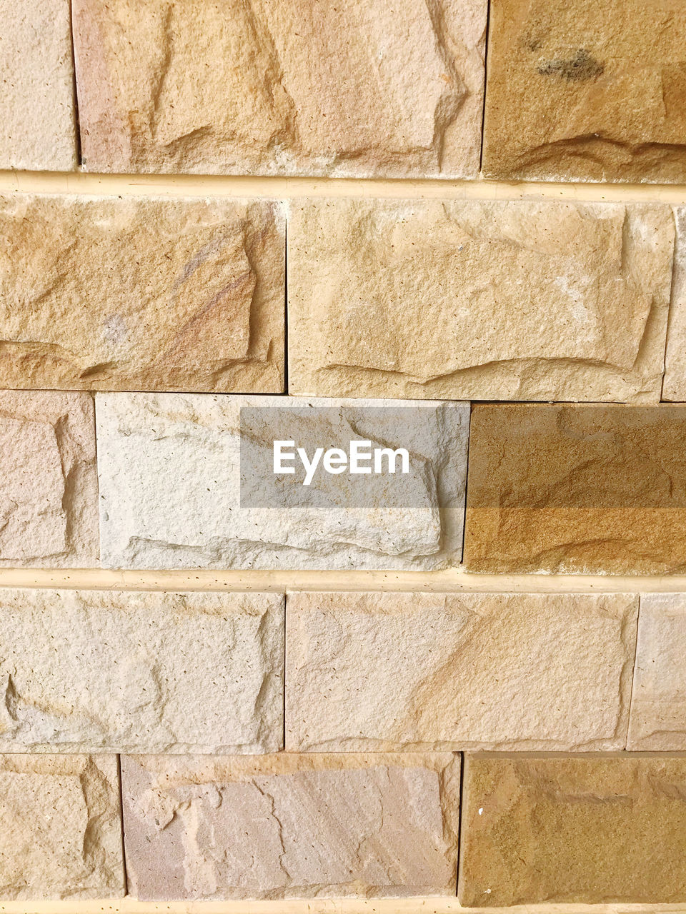 FULL FRAME SHOT OF BRICK WALL WITH OLD BUILDING