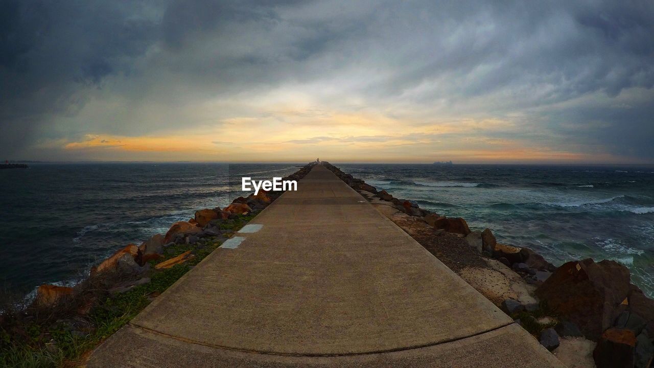 VIEW OF SEA AGAINST CLOUDY SKY DURING SUNSET