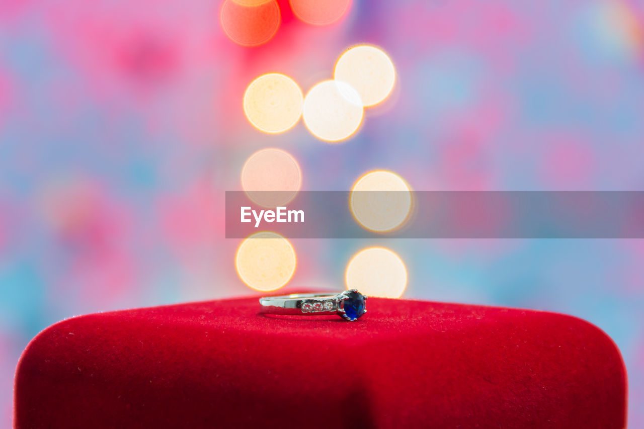 Close-up of wedding ring against illuminated lighting