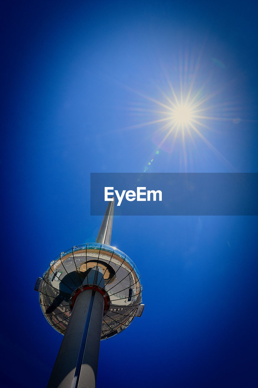 LOW ANGLE VIEW OF TOWER AGAINST BLUE SKY ON SUNNY DAY