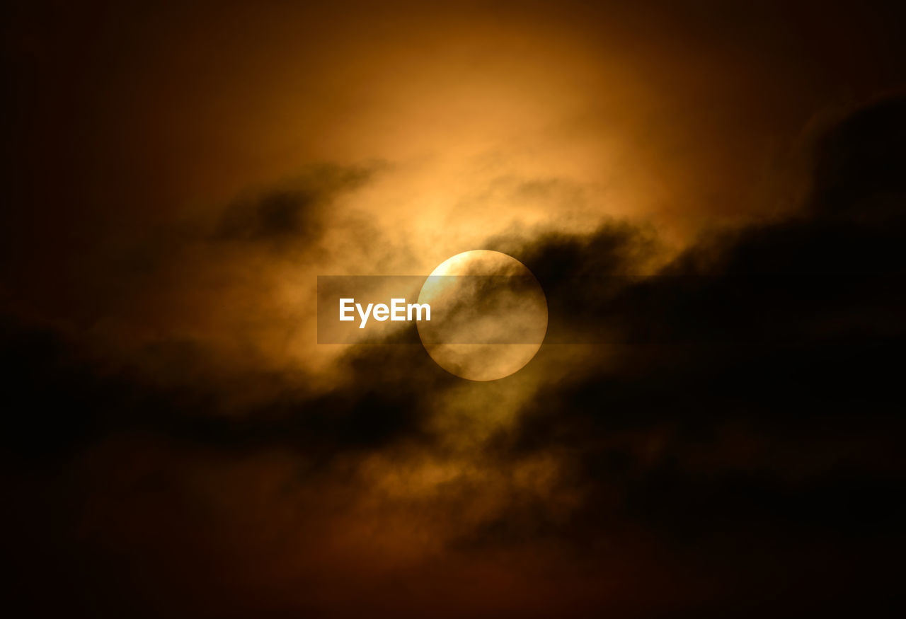 Low angle view of moon against sky at sunset