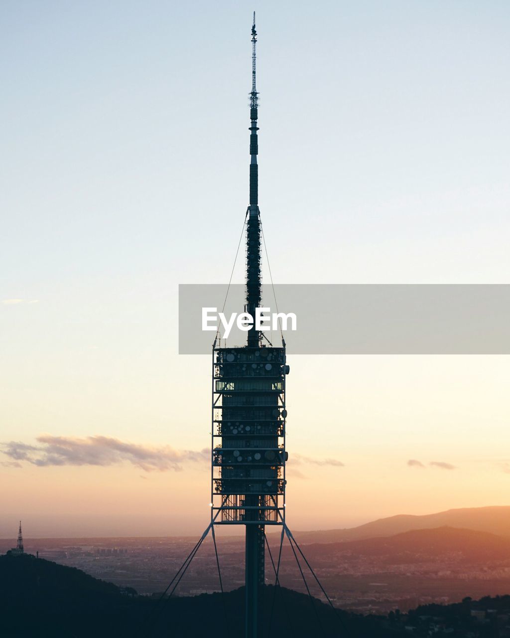 SILHOUETTE OF COMMUNICATIONS TOWER AGAINST SKY