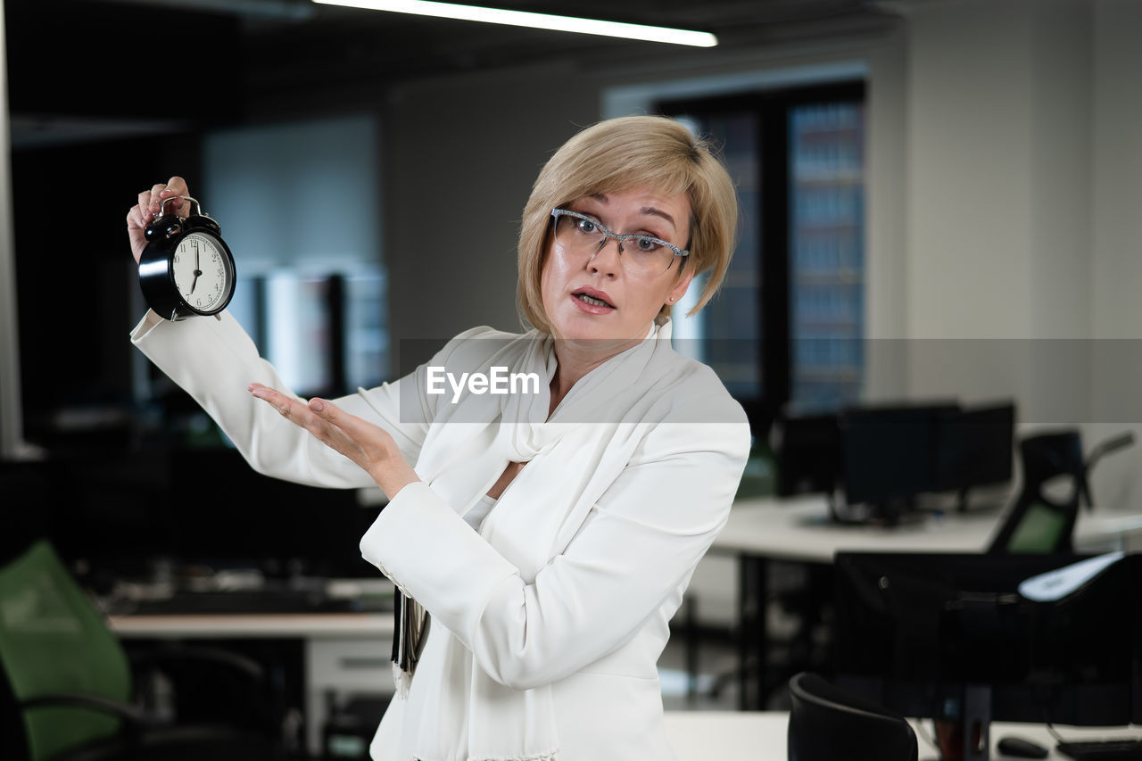 portrait of smiling young woman standing in laboratory