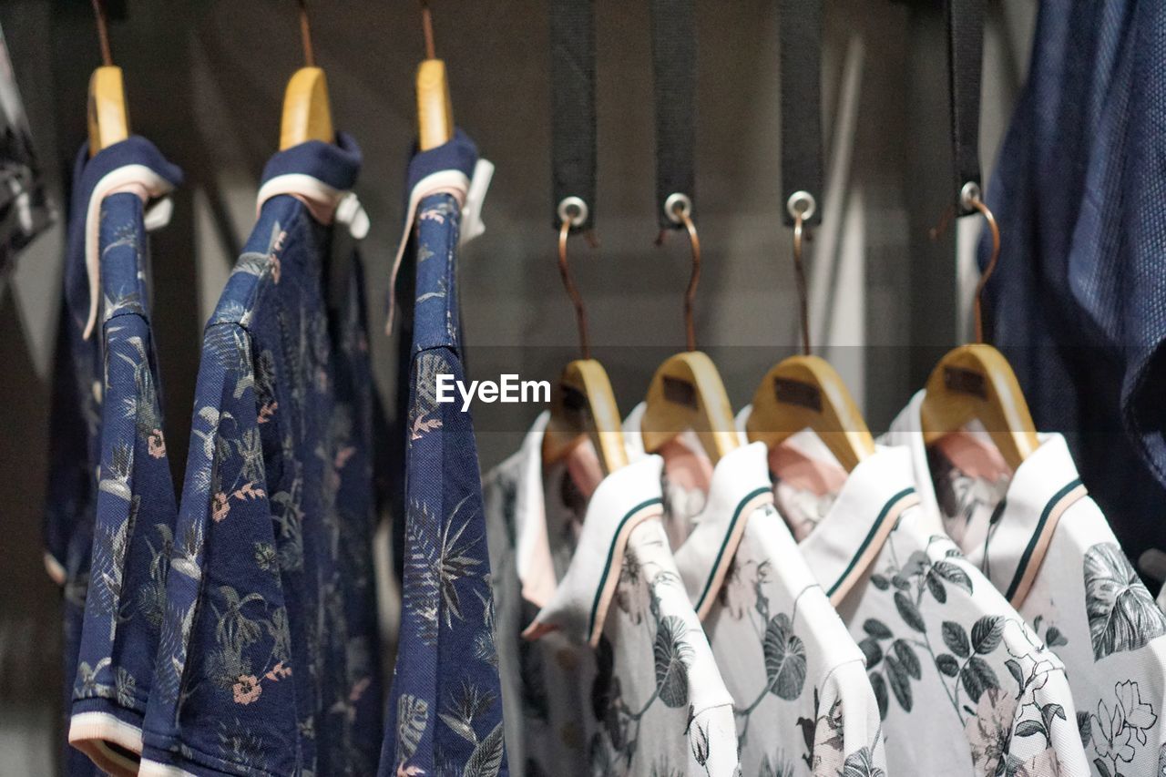 Close-up of clothes hanging on rack for sale in store