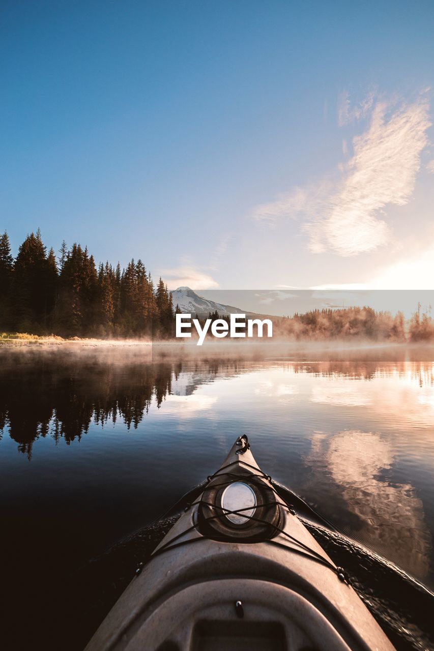 Cropped image of boat on lake against sky