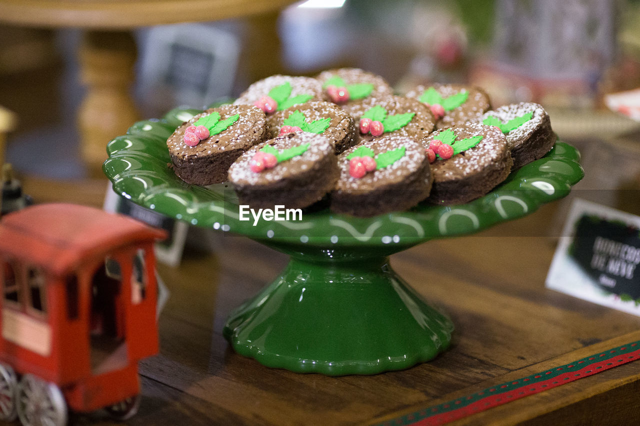 CLOSE-UP OF CAKE ON TABLE AGAINST WALL