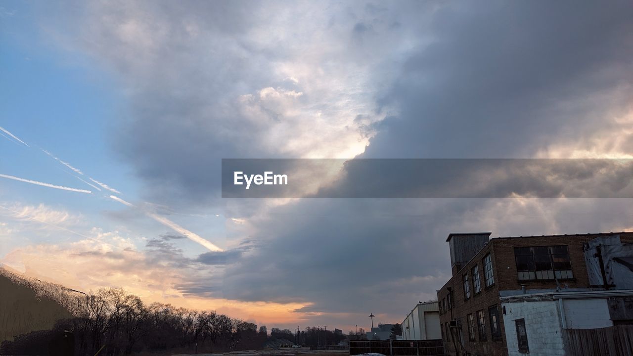 sky, cloud, evening, architecture, dusk, nature, built structure, building exterior, sunset, sunlight, building, no people, city, beauty in nature, transportation, outdoors, horizon, snow, storm, dramatic sky, house, environment, tree