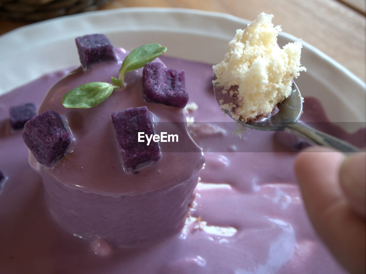 CLOSE-UP OF HAND HOLDING ICE CREAM IN PLATE WITH CHOCOLATE