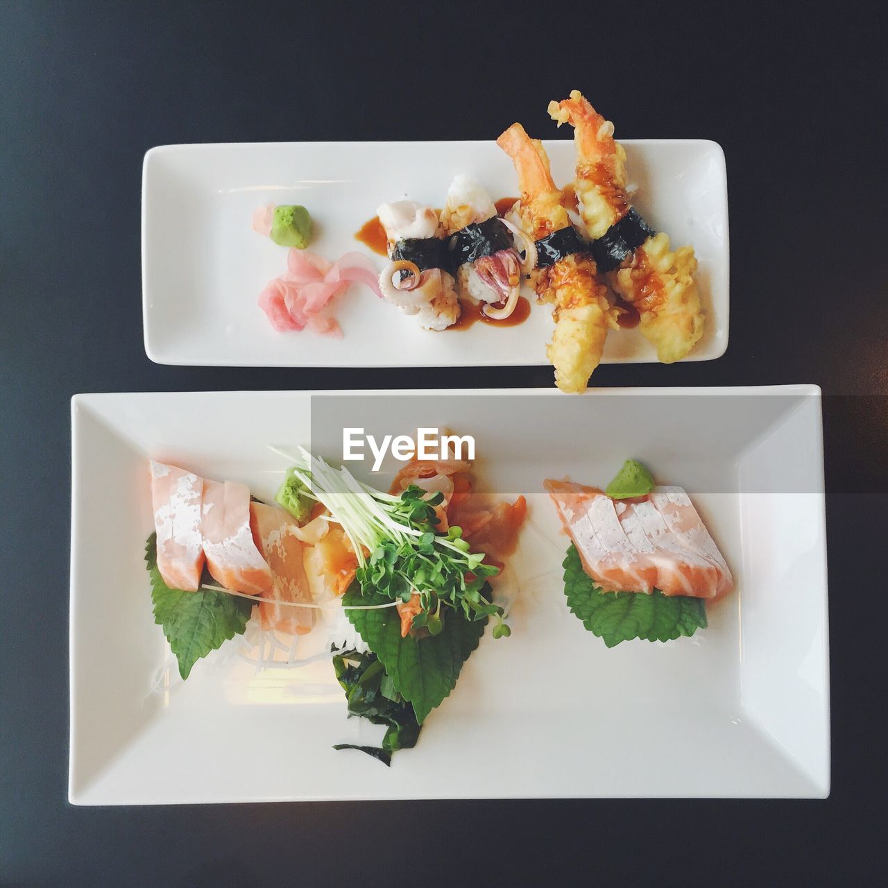 High angle view of seafood served in plate against black background