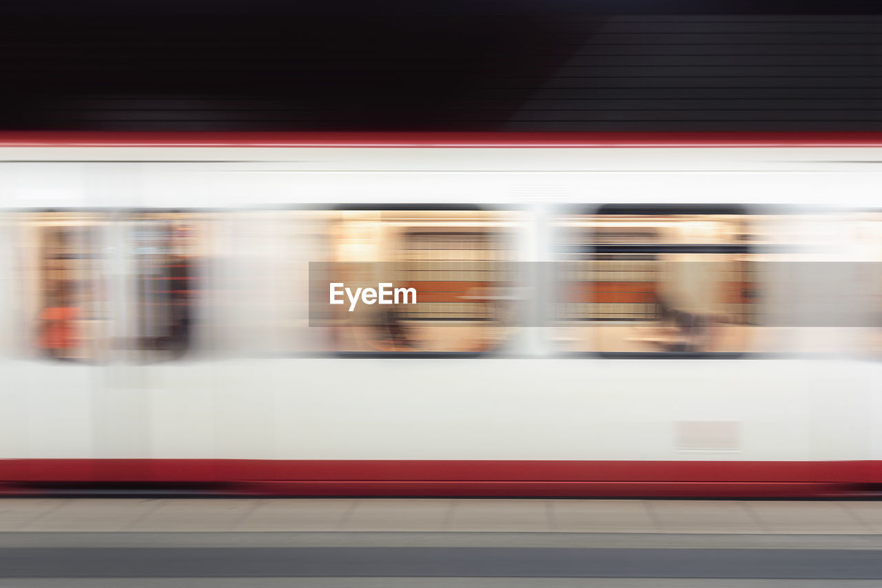 Blurred motion of train at railroad station