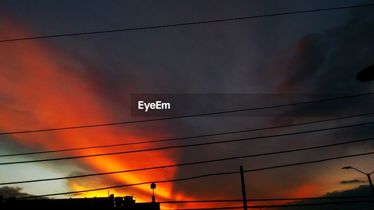 LOW ANGLE VIEW OF POWER LINES AGAINST SKY