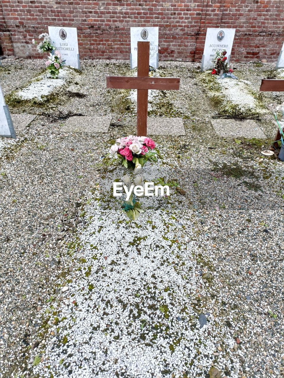 grave, cemetery, religion, cross, flower, stone, day, belief, spirituality, nature, death, plant, no people, flowering plant, tombstone, architecture, high angle view, built structure, catholicism, outdoors, religious item, memorial, sadness, yard