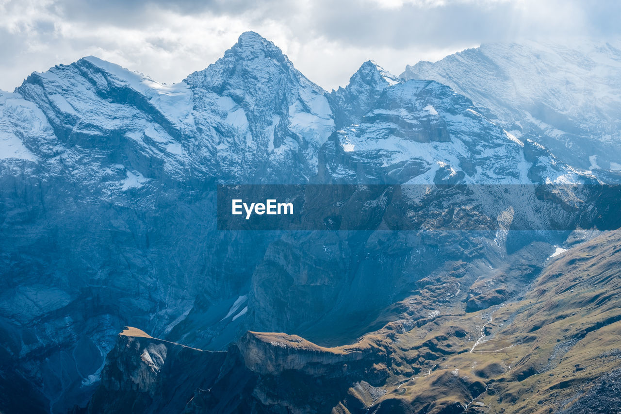 Scenic view of snowcapped mountains against sky