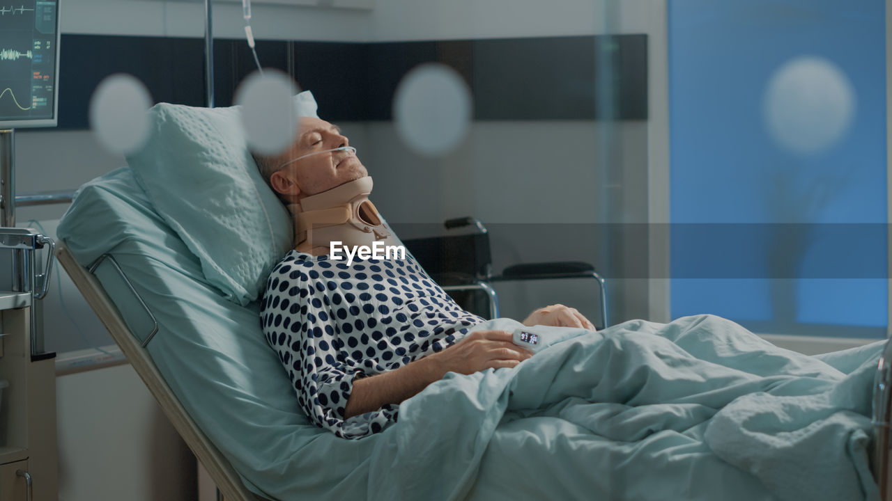 Man resting on hospital bed