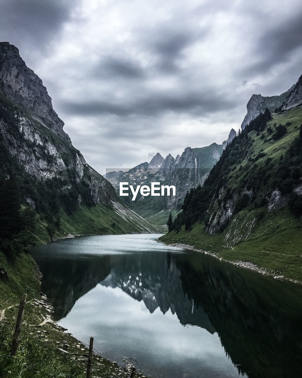 Scenic view of lake and mountains against sky