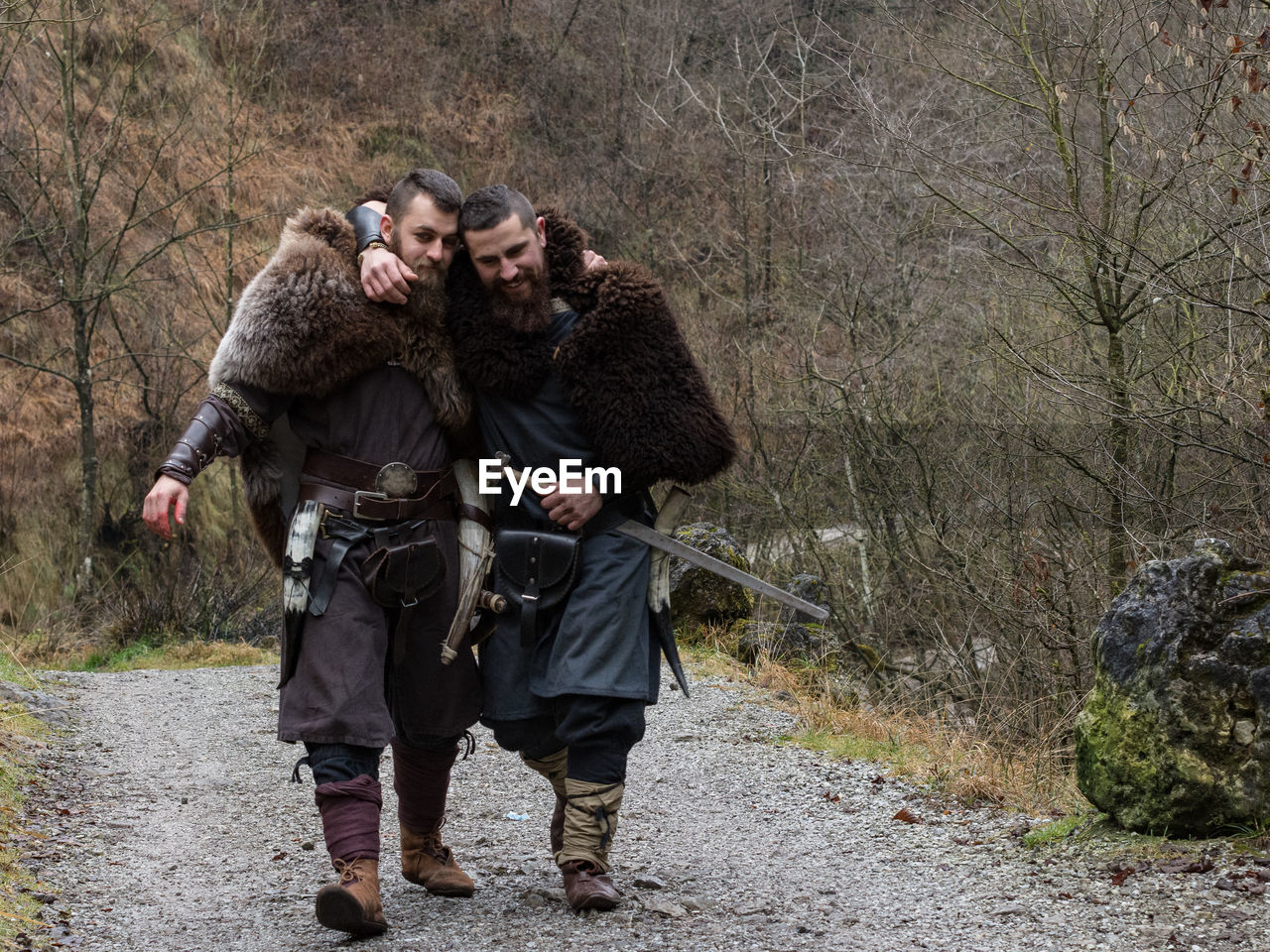 Portrait of two warriors walking in forest