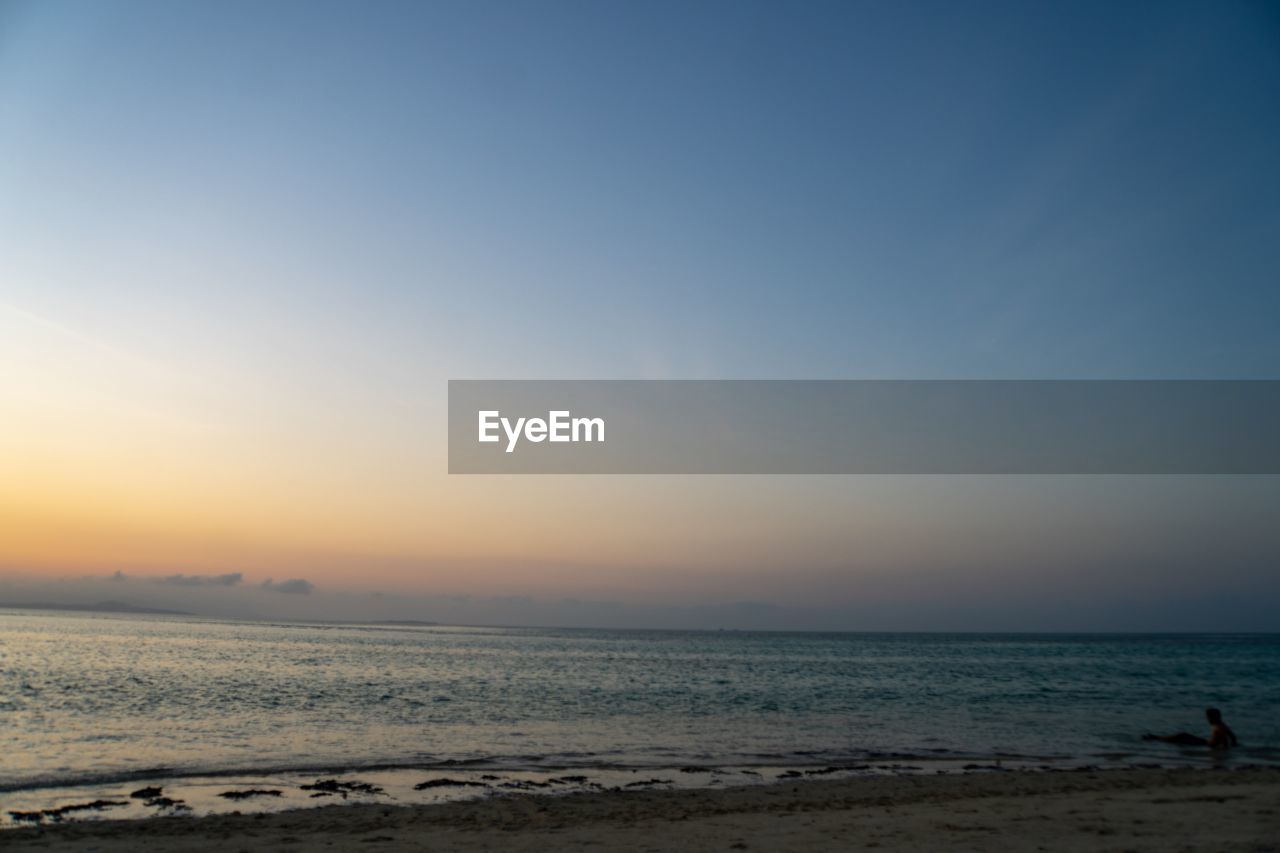 Scenic view of sea against clear sky during sunset in okinawa japan