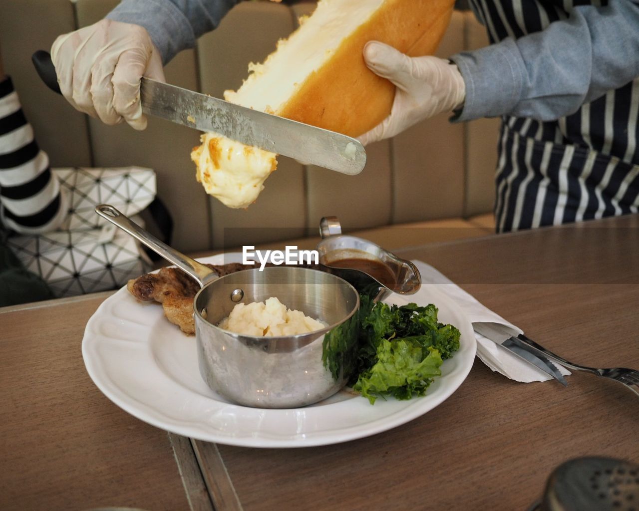 Midsection of male chef preparing food at table