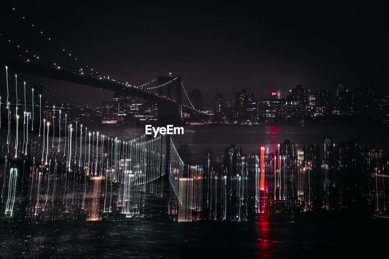 Double exposure of manhattan skyline, brooklyn bridge from dumbo park in new york city, usa