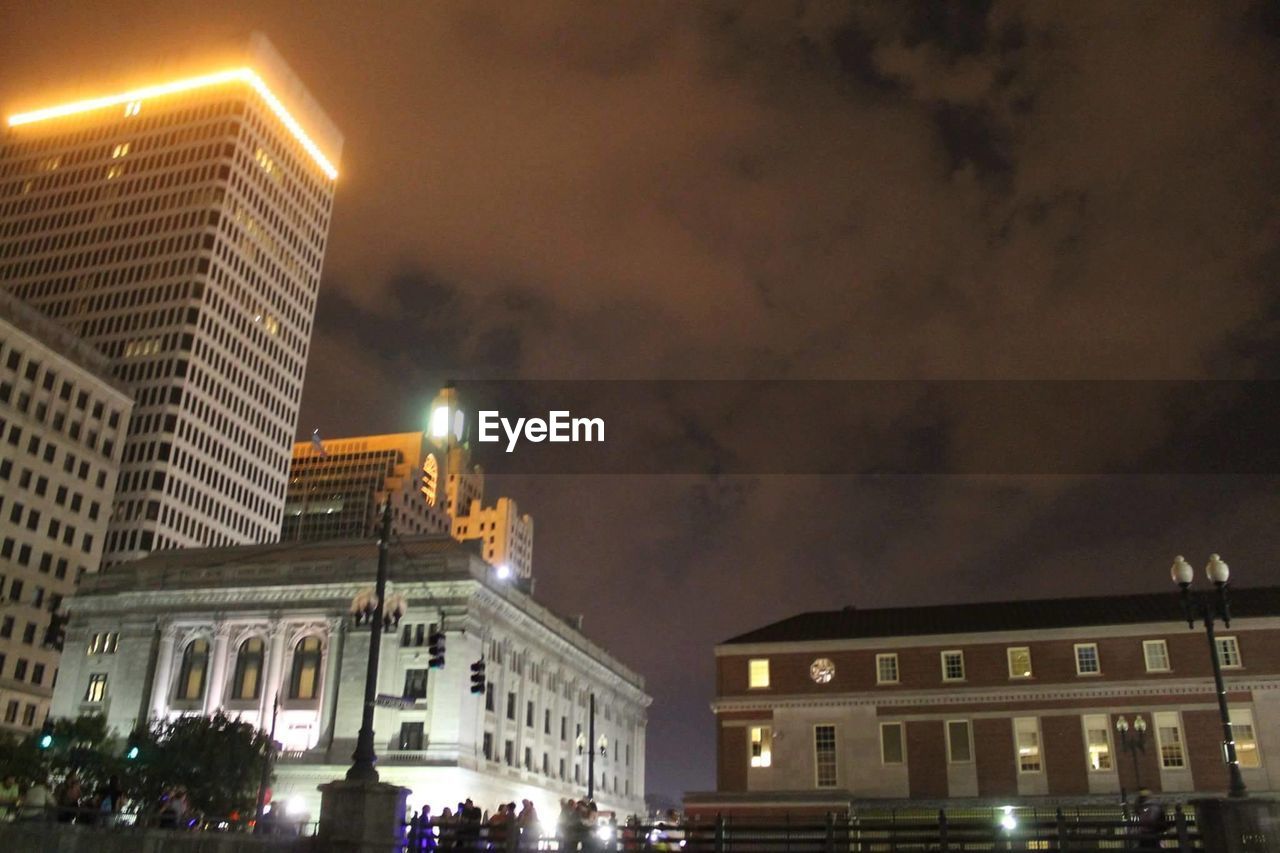 LOW ANGLE VIEW OF ILLUMINATED BUILDING AT NIGHT