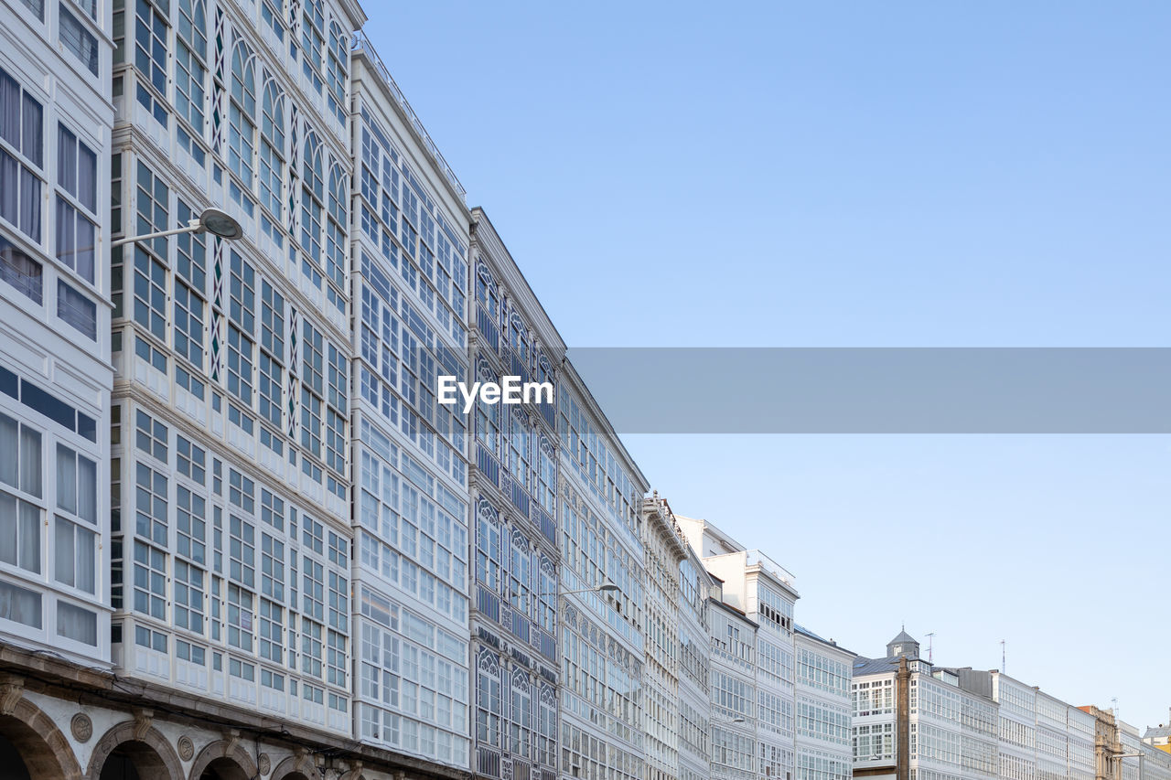 Low angle view of modern building against clear blue sky