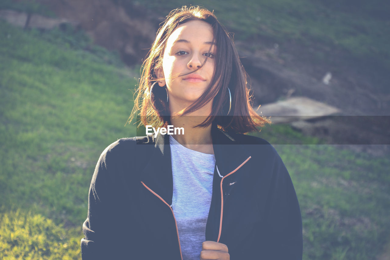 Portrait of teenage girl standing on mountain