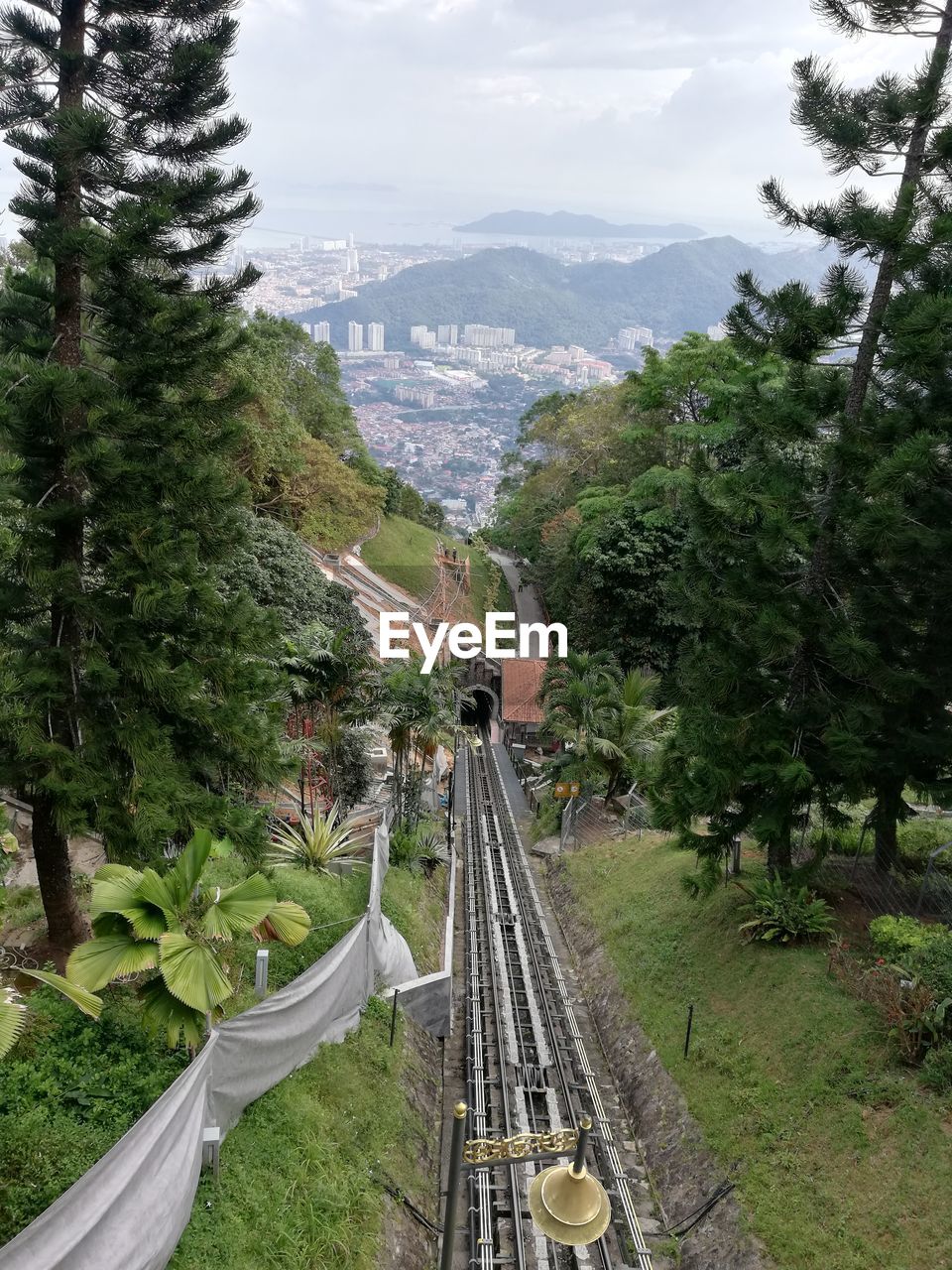 High angle view of railroad tracks amidst trees against sky