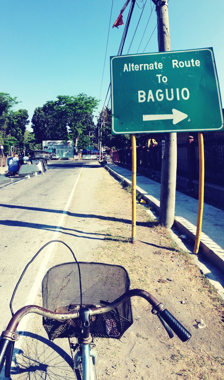 Road sign against clear sky