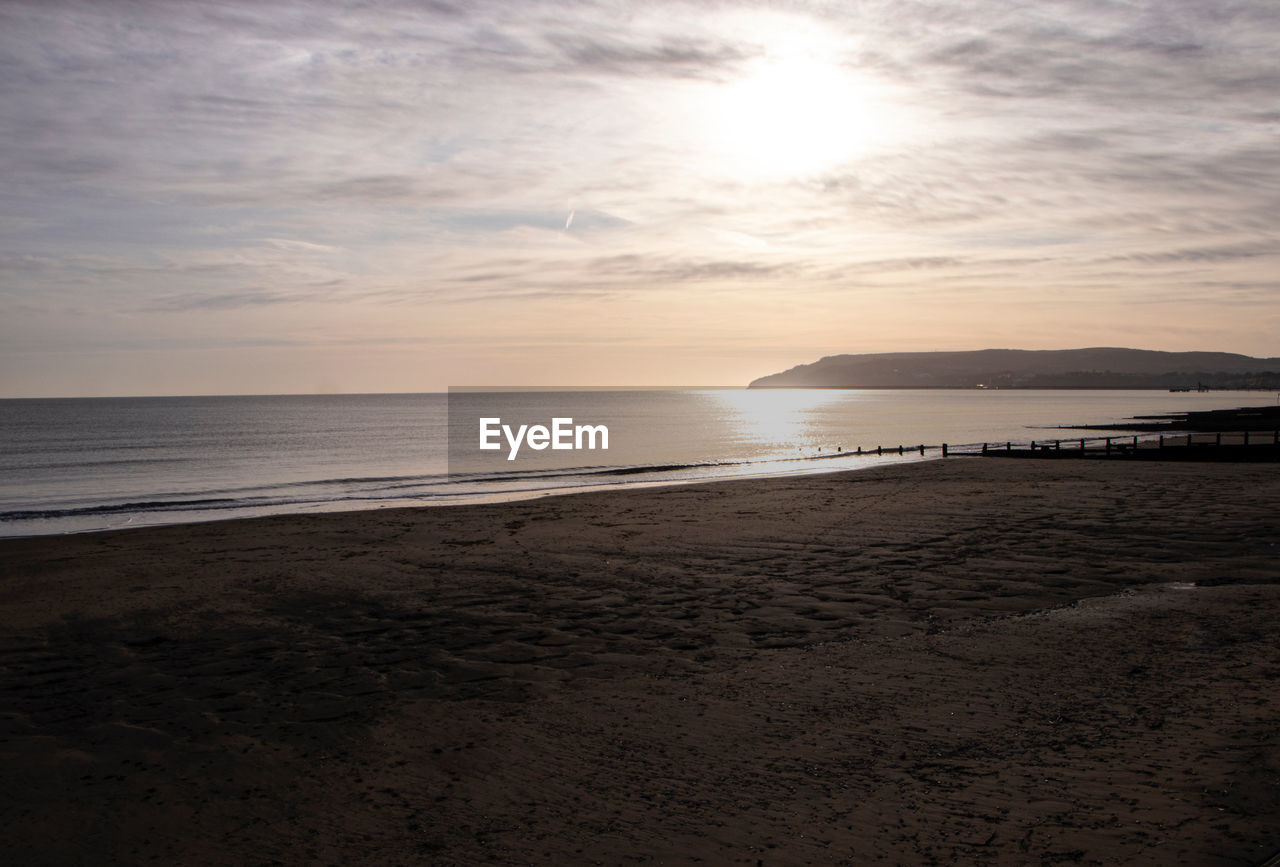 Scenic view of beach against sky during sunset